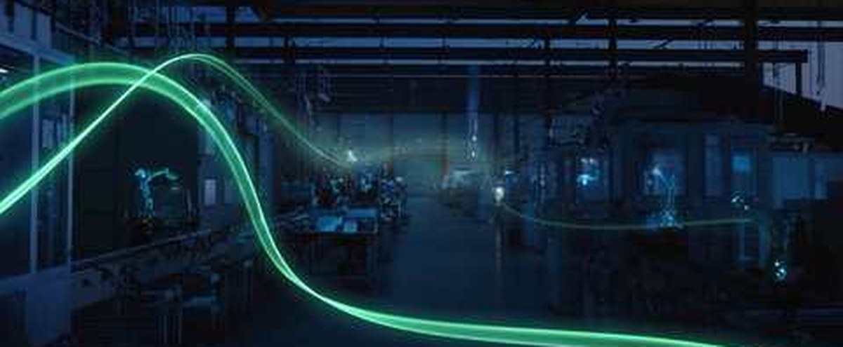 A South African manufacturing floor at dusk, with a glowing green data line representing AI moving through production systems